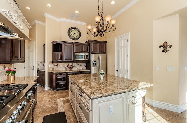 14505 Blue Drake Ln, Prather, CA 93651 - kitchen featuring stainless steel appliances, crown molding, wall chimney range hood, light stone counters, and tasteful backsplash