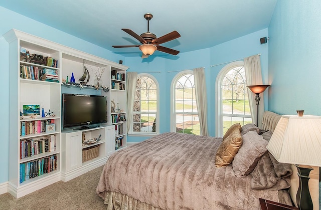 carpeted bedroom with visible vents and a ceiling fan