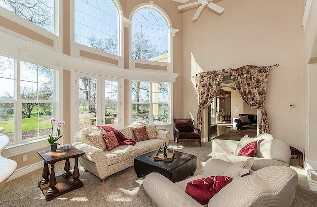 14505 Blue Drake Ln, Prather, CA 93651 - carpeted living room featuring healthy amount of natural light, a towering ceiling, ceiling fan, and arched walkways