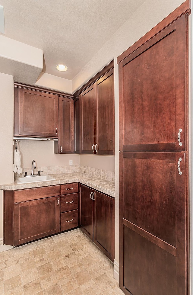 14505 Blue Drake Ln, Prather, CA 93651 - kitchen with a sink, light countertops, dark brown cabinetry, and recessed lighting