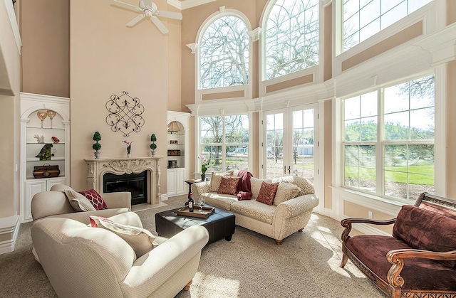14505 Blue Drake Ln, Prather, CA 93651 - living area featuring a high ceiling, carpet flooring, built in shelves, and a fireplace
