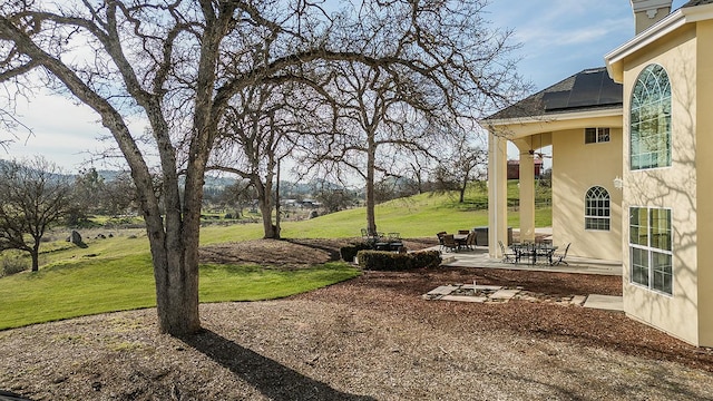 view of yard with outdoor dining area and a patio