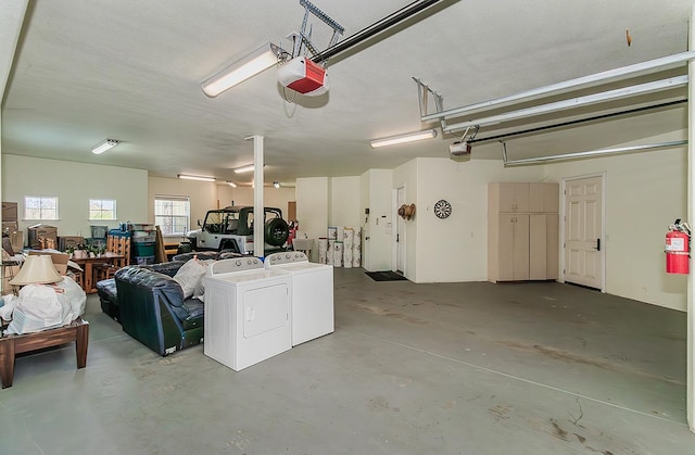 garage featuring washer and dryer and a garage door opener