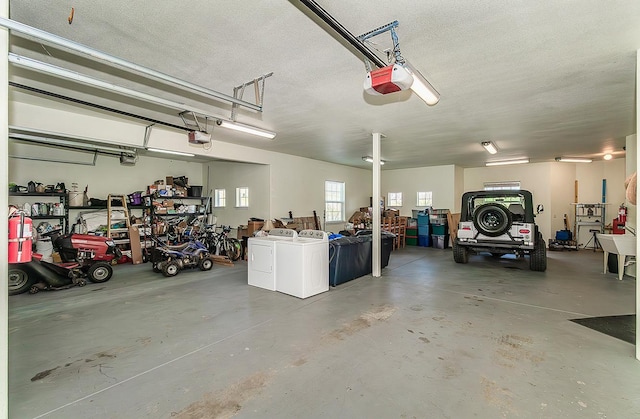 garage with a garage door opener and washing machine and clothes dryer