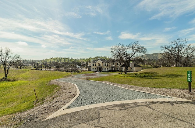 surrounding community featuring a mountain view and a yard