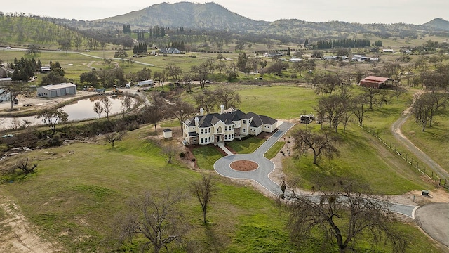 drone / aerial view featuring a rural view and a mountain view