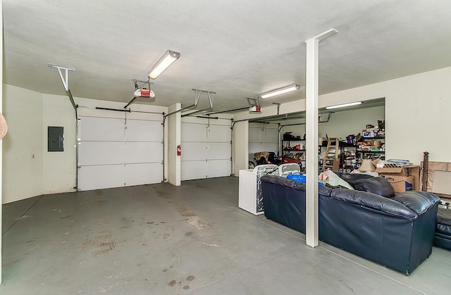 garage featuring electric panel and a garage door opener