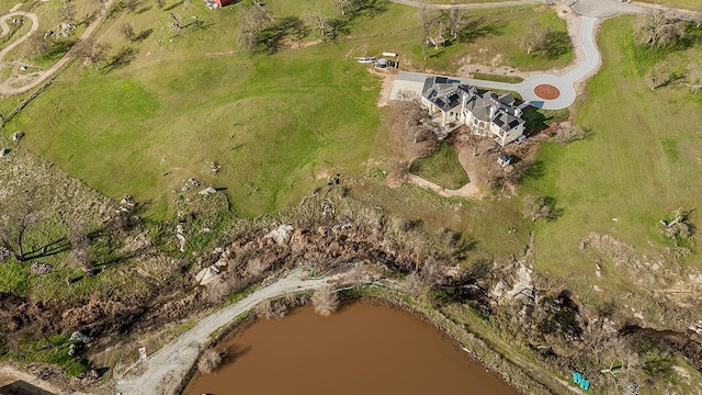 birds eye view of property with a rural view and a water view