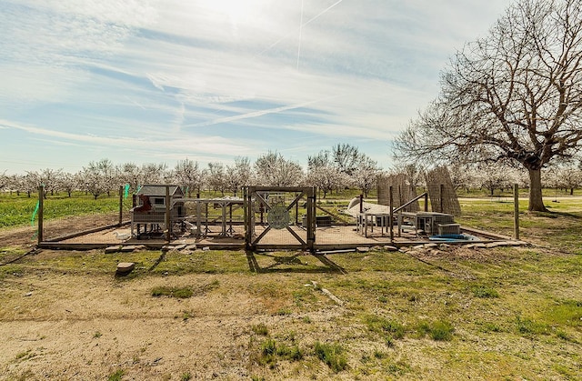 view of jungle gym with a yard and a rural view