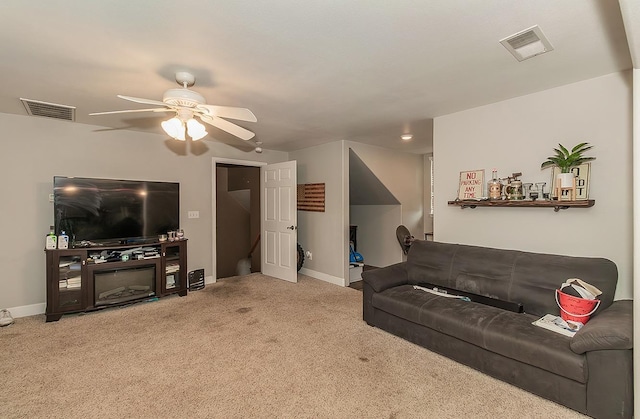 carpeted living area featuring baseboards, visible vents, and a ceiling fan