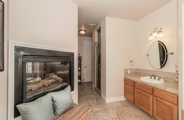 bathroom featuring visible vents, vanity, and baseboards