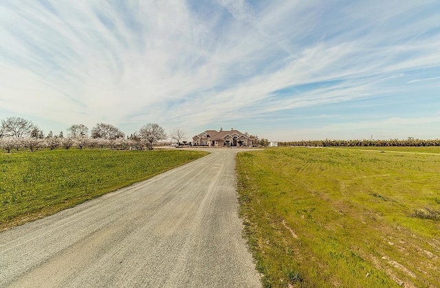 view of road featuring driveway and a rural view