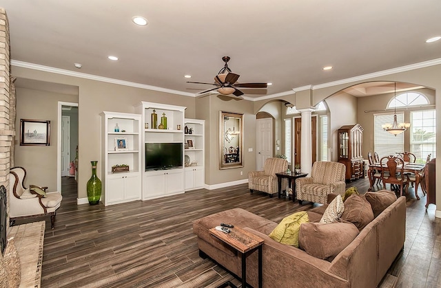 living room with dark wood-style floors, arched walkways, crown molding, and ceiling fan with notable chandelier