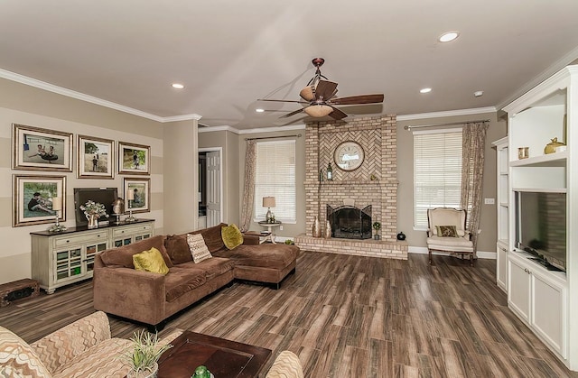 living room featuring a fireplace, ornamental molding, dark wood finished floors, and recessed lighting