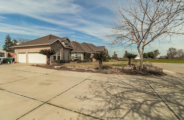 view of property exterior featuring concrete driveway and an attached garage