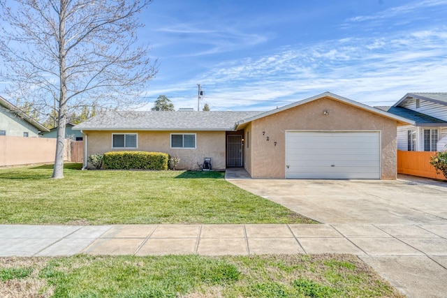 ranch-style home featuring a front yard, fence, an attached garage, and stucco siding