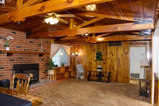 living room featuring visible vents, carpet floors, wood walls, and wooden ceiling