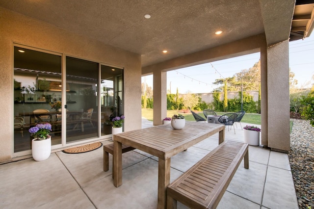 view of patio featuring fence and outdoor dining area