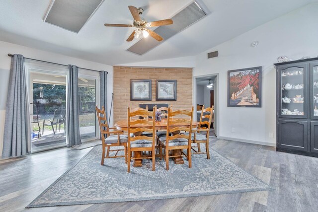 dining area with dark wood-style flooring, lofted ceiling, visible vents, a ceiling fan, and baseboards