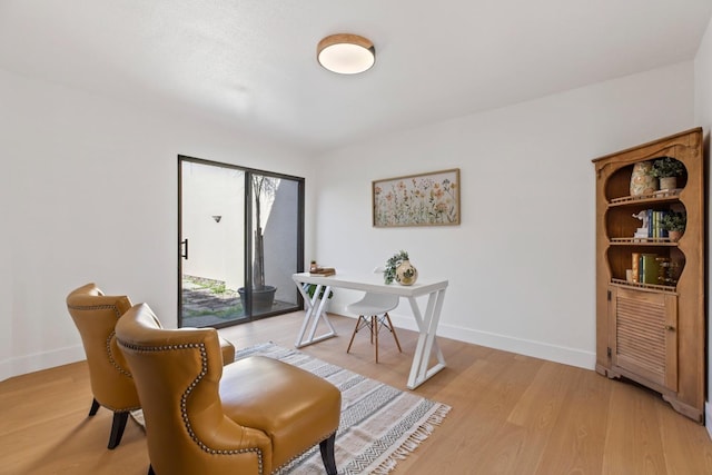 office featuring light wood-type flooring and baseboards