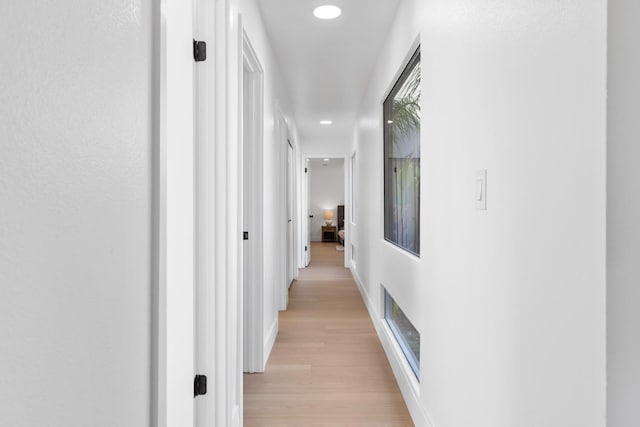 hall featuring recessed lighting, visible vents, light wood-style flooring, and baseboards