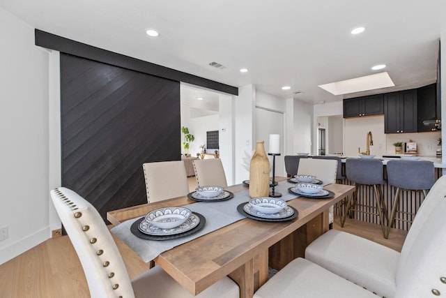 dining space featuring light wood-style floors, visible vents, and recessed lighting