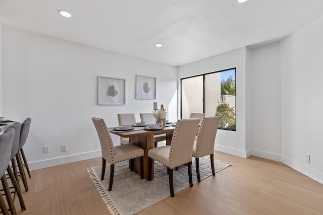 dining area featuring recessed lighting, light wood-type flooring, and baseboards