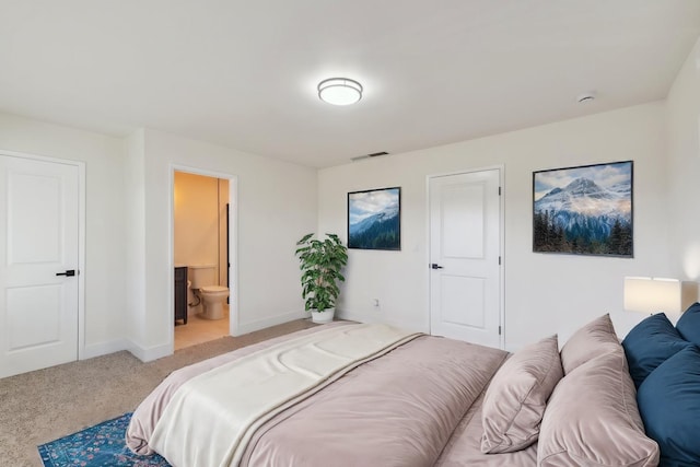 bedroom featuring carpet, visible vents, baseboards, and ensuite bathroom