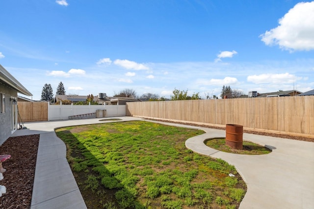 view of yard featuring a patio and a fenced backyard