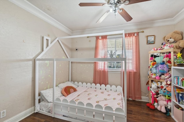 bedroom featuring baseboards, dark wood finished floors, and crown molding