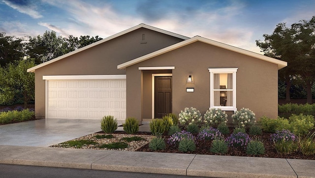 ranch-style house with concrete driveway, an attached garage, and stucco siding