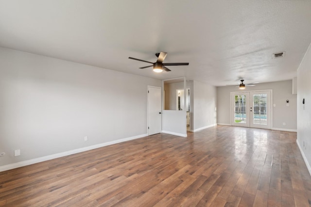 spare room featuring a ceiling fan, french doors, baseboards, and wood finished floors