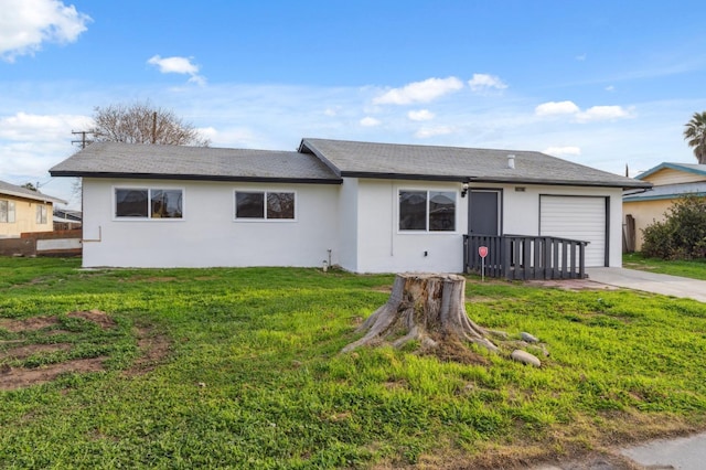 ranch-style house with a garage, a front lawn, concrete driveway, and stucco siding