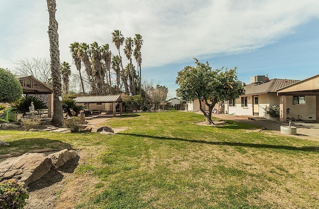 view of yard featuring central AC and a gazebo