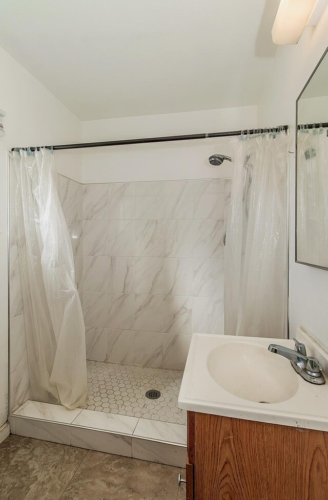 bathroom with a stall shower and vanity