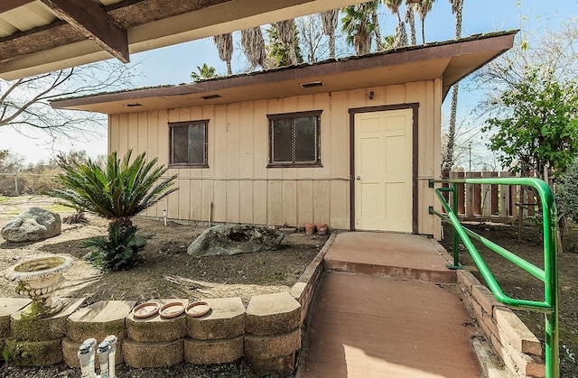 view of outbuilding featuring fence