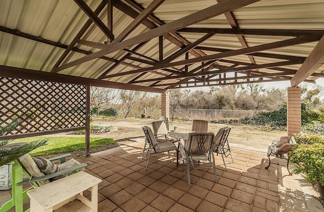 view of patio / terrace with outdoor dining area, fence, and a gazebo