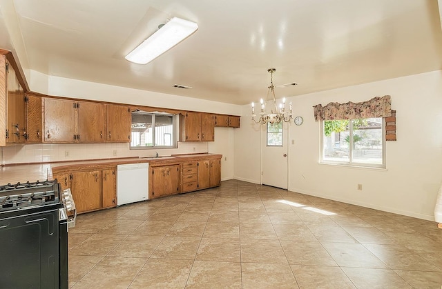 kitchen featuring brown cabinets, decorative light fixtures, light countertops, gas range, and dishwasher