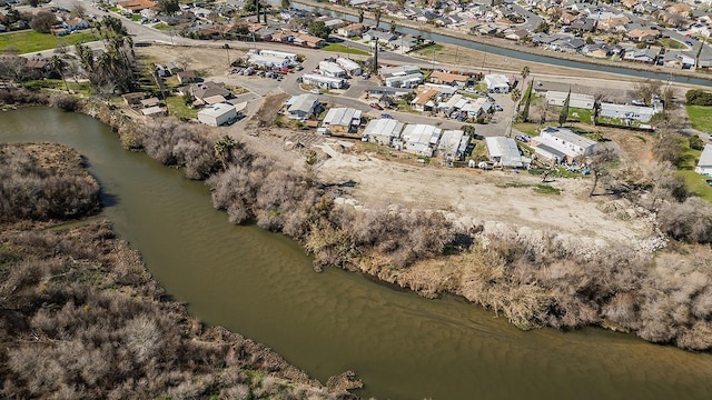 drone / aerial view with a water view and a residential view