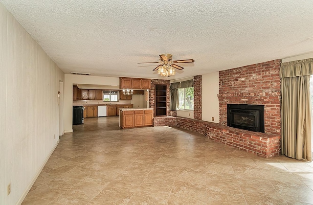 unfurnished living room featuring a brick fireplace, a textured ceiling, visible vents, and a ceiling fan