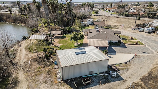 birds eye view of property featuring a water view and a residential view