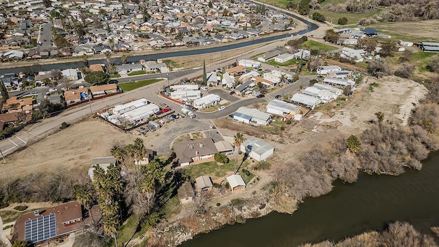 birds eye view of property featuring a residential view and a water view