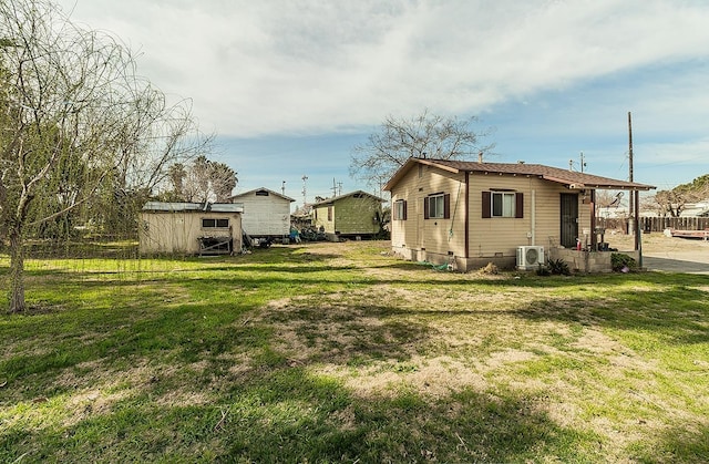 exterior space with a storage shed, a yard, crawl space, and an outbuilding