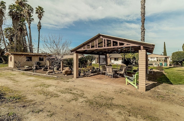 view of home's community featuring an outbuilding, a gazebo, and a patio