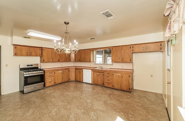 kitchen with visible vents, gas range, brown cabinets, hanging light fixtures, and light countertops