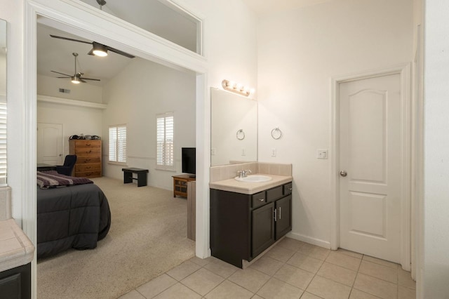 bathroom with visible vents, ceiling fan, vanity, ensuite bath, and tile patterned floors