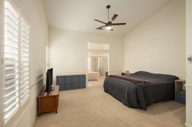 bedroom with ensuite bath, high vaulted ceiling, ceiling fan, and carpet flooring