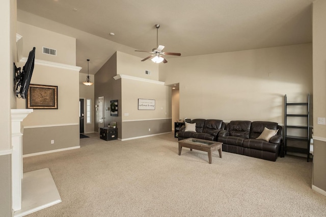 living area with ceiling fan, high vaulted ceiling, visible vents, and light colored carpet