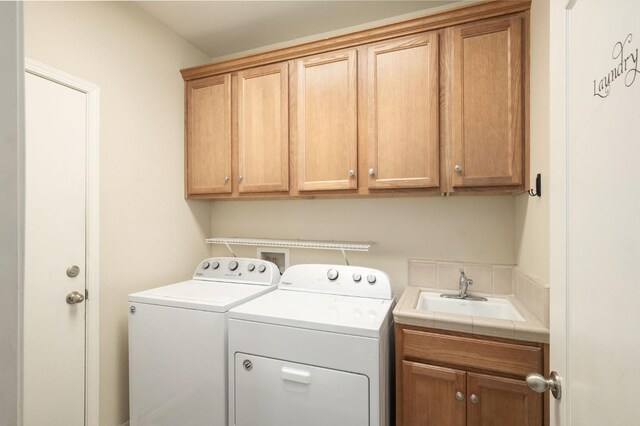 laundry room featuring a sink, cabinet space, and washer and dryer