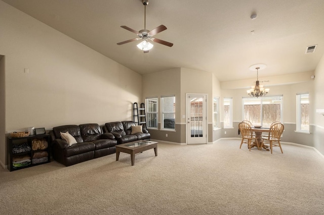 living room featuring light colored carpet, visible vents, baseboards, and ceiling fan with notable chandelier